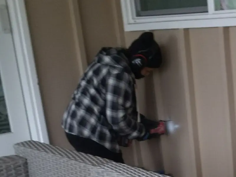 Professional electrician installing an exterior outlet in Balm